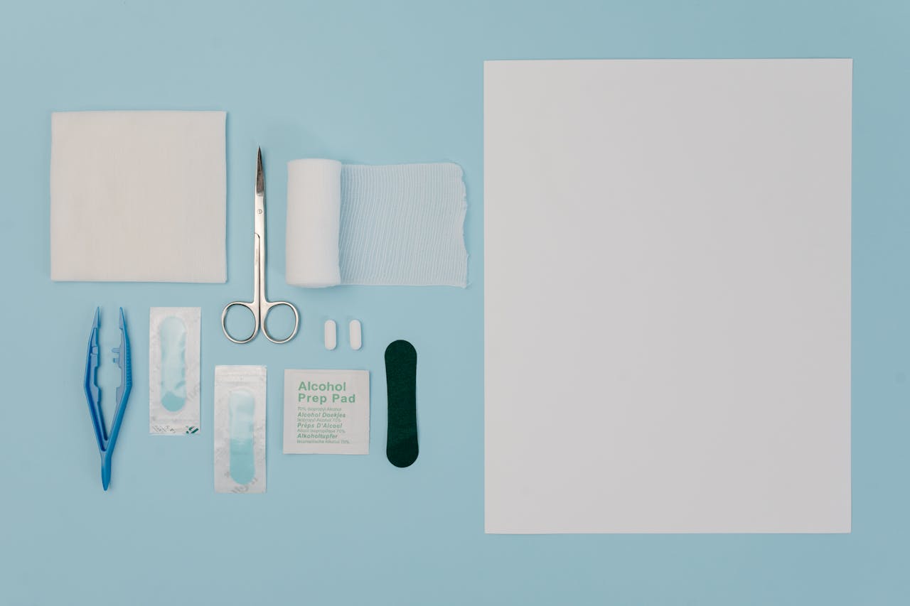 درباره ما Organized display of medical tools and supplies including gauze, scissors, and bandages on a blue surface.